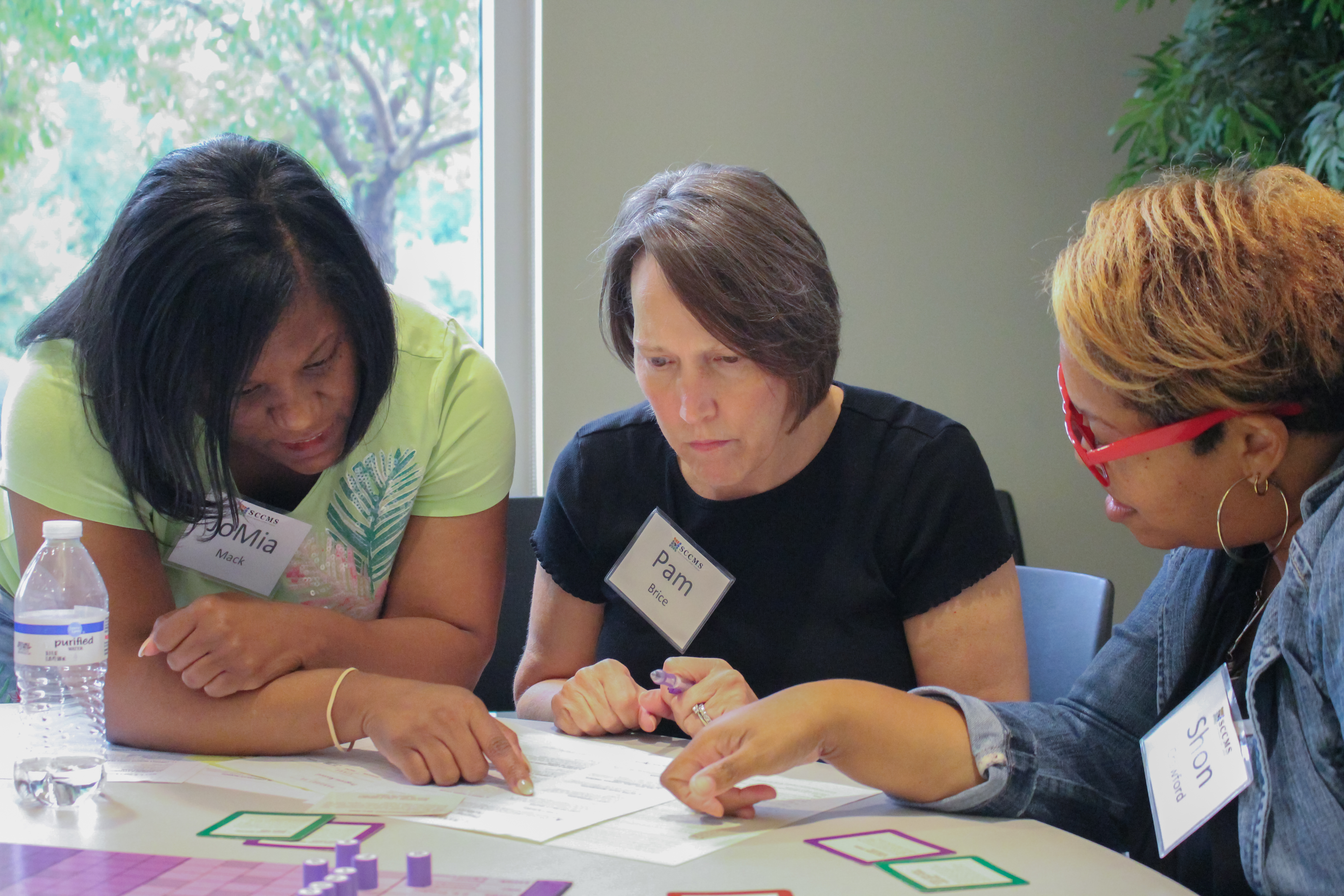 Three woman collaborating (opens link in new window)